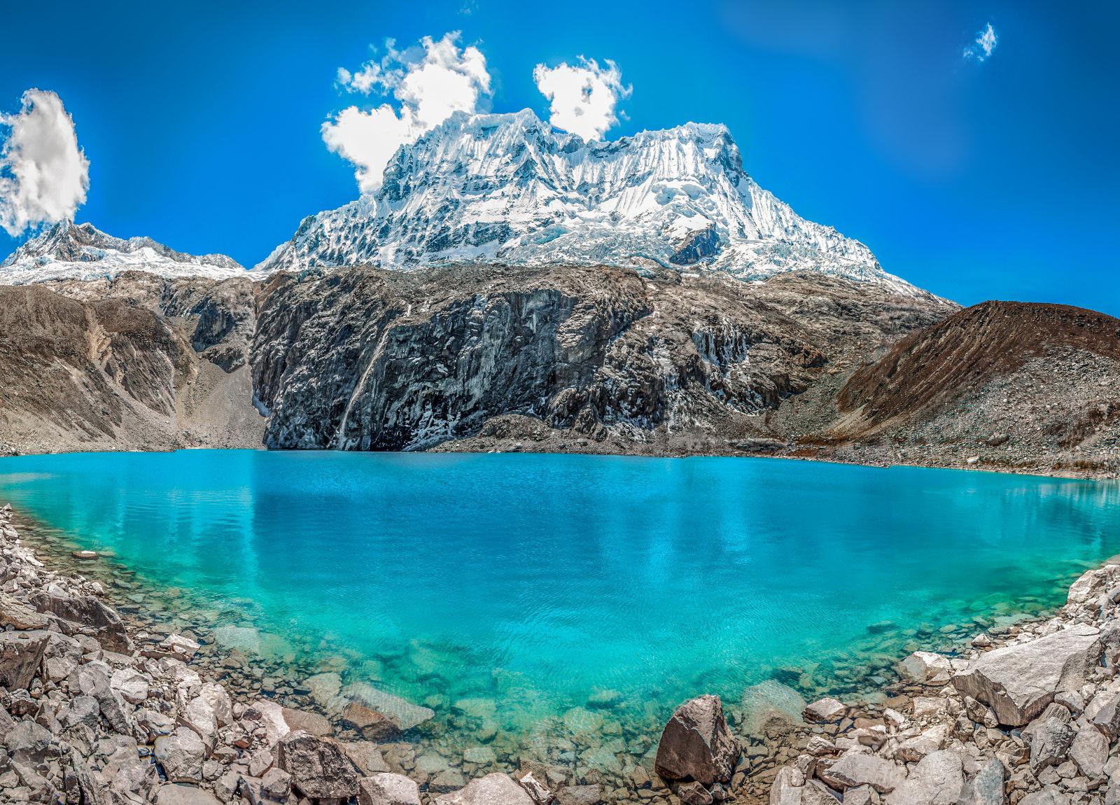 Peruvian mountain with a vivid blue lake in front of it